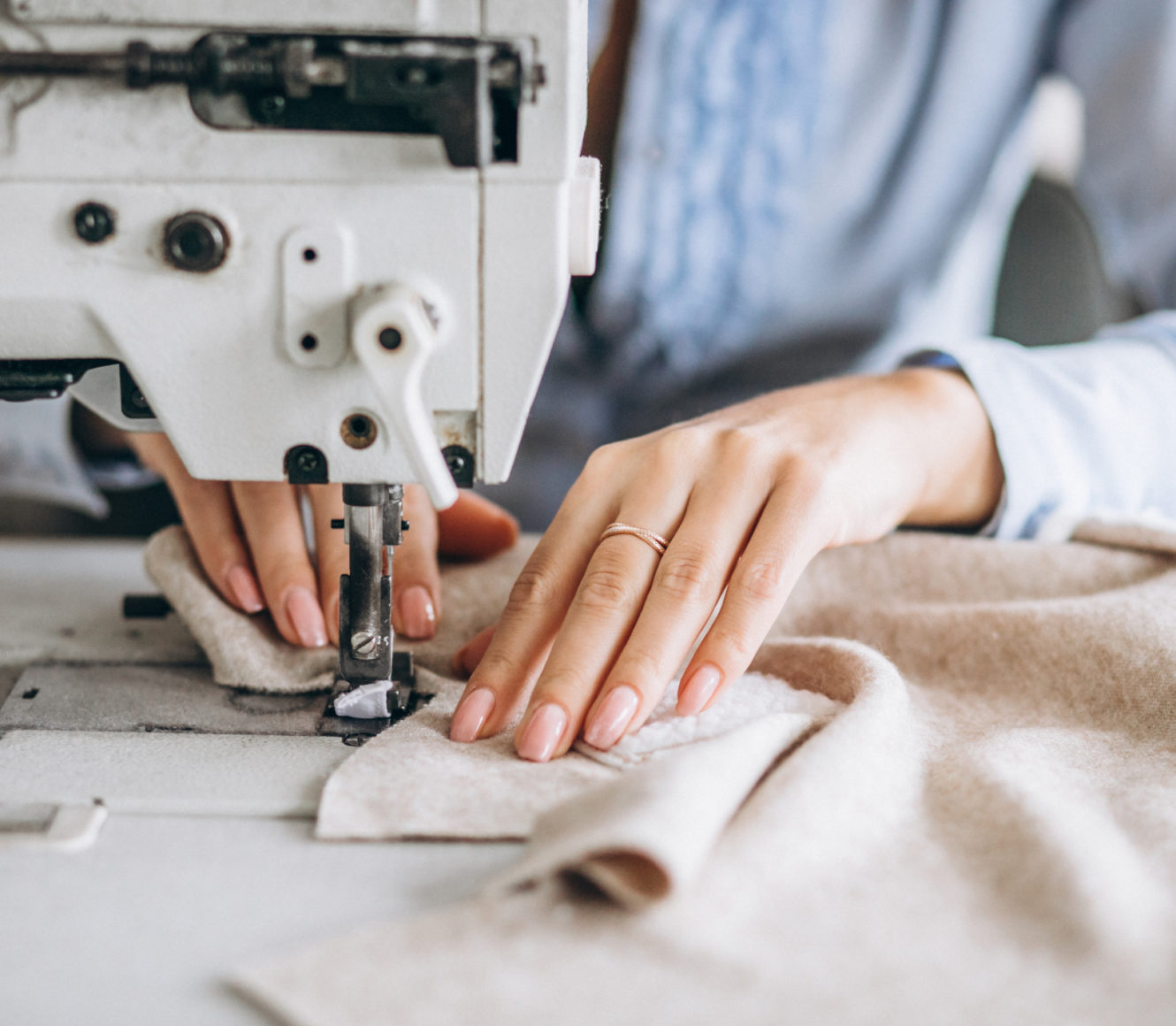 Woman tailor working at the sewing factory Woman tailor working at the sewing factory